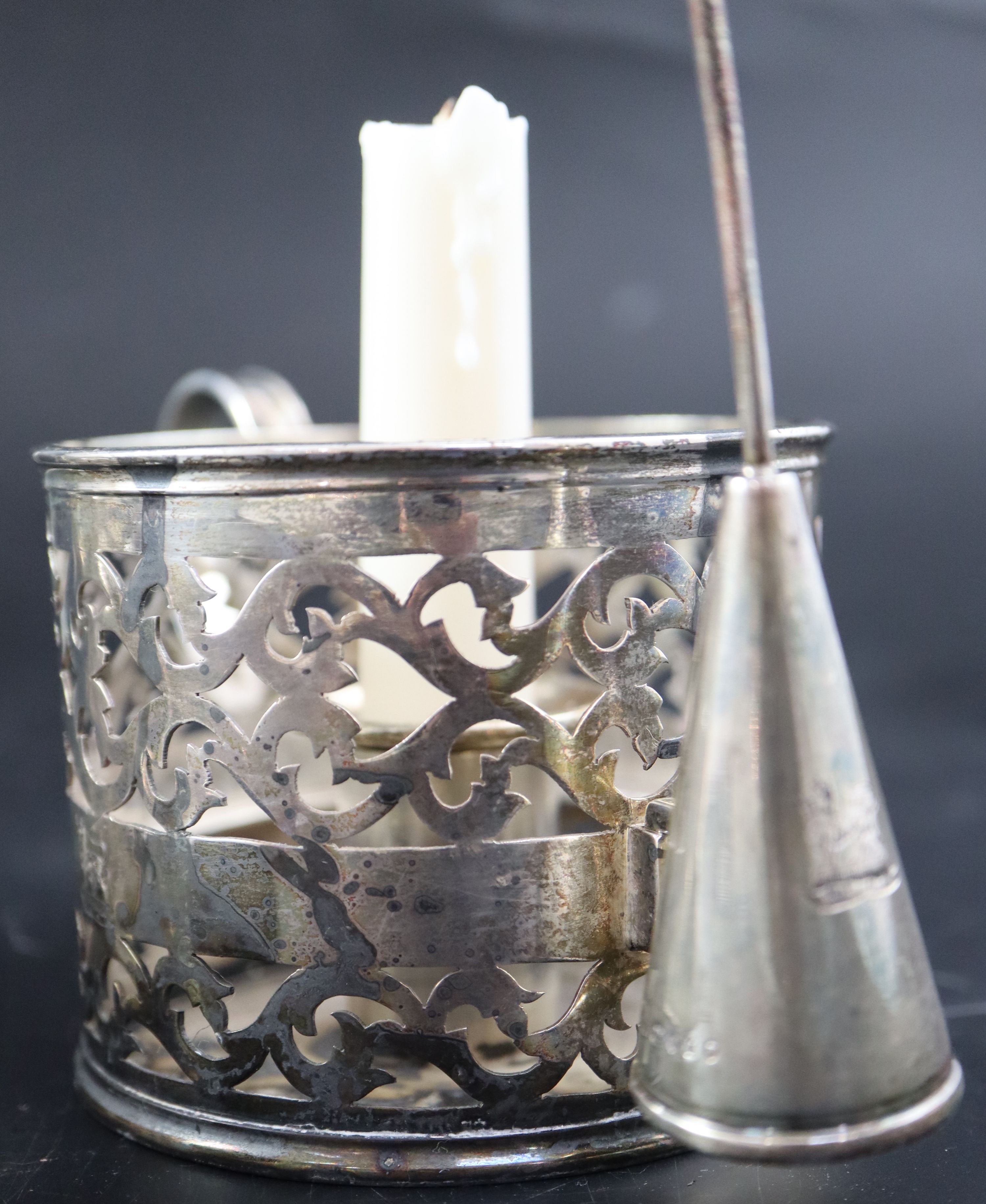 A pair of Victorian pierced silver cylindrical chambersticks, E.T. London, 1875 with three extinguishers, two associated,